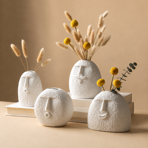 Set of four abstract face ceramic vases styled with pampas grass and craspedia