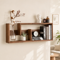 Dark walnut floating wood display shelf with books, clock, succulent and cotton stem vase on a cream wall