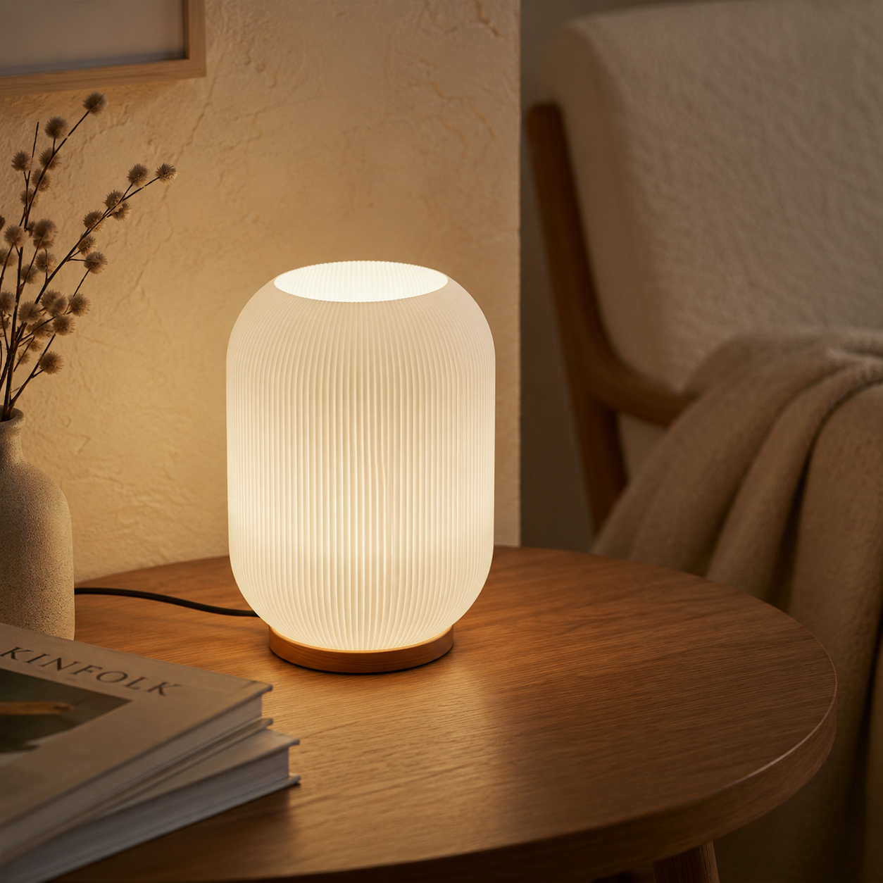 Frosted ribbed glass lamp with wood base on a round oak side table next to an armchair